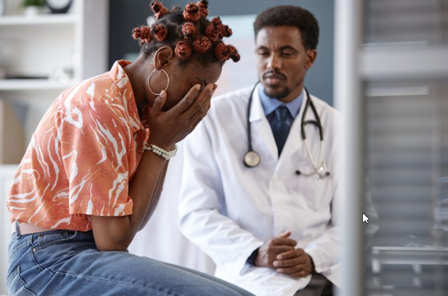 Depressed woman having psychotherapy session at doctor's office.